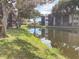 Scenic view of the building overlooking the lake with lush greenery and mature trees casting shadows on the grassy banks at 7941 58Th N Ave # 106, St Petersburg, FL 33709