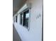 Exterior view of building with numbered unit, featuring impact windows and neutral color, reflecting modern functionality at 7941 58Th N Ave # 106, St Petersburg, FL 33709