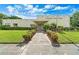 Attractive community center featuring a well-maintained lawn, neat hedges, and a welcoming entrance at 7941 58Th N Ave # 106, St Petersburg, FL 33709