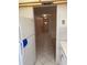 Hallway with white tile flooring leading to front door from a kitchen with white appliances and cabinets at 7941 58Th N Ave # 106, St Petersburg, FL 33709