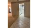 The home's hallway featuring tile and a view of the kitchen, providing a clean and bright transition at 7941 58Th N Ave # 106, St Petersburg, FL 33709