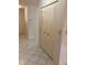 Hallway with tiled flooring and closet doors, providing access to different areas of the home at 7941 58Th N Ave # 106, St Petersburg, FL 33709