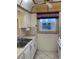 Kitchen area with white cabinets, double sinks, and a window at 7941 58Th N Ave # 106, St Petersburg, FL 33709