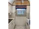 Kitchen with white cabinets, window, and tiled floors at 7941 58Th N Ave # 106, St Petersburg, FL 33709
