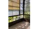 Enclosed lanai with window shades and view of the surrounding landscaping at 7941 58Th N Ave # 106, St Petersburg, FL 33709