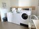 Commercial laundry room featuring washing machines, coin dispensers, and a folding table at 7941 58Th N Ave # 106, St Petersburg, FL 33709