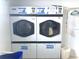 Commercial laundry room featuring two large capacity dryers with lint traps at 7941 58Th N Ave # 106, St Petersburg, FL 33709
