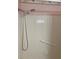 Standard shower head with white tile backsplash and decorative floral wallpaper at 7941 58Th N Ave # 106, St Petersburg, FL 33709