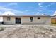 An exterior view shows the home's backyard with windows and sliding glass doors at 811 Pebblewood Dr, Brandon, FL 33511