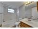 Bathroom features white tile, shower and tub combo, and a light vanity at 811 Pebblewood Dr, Brandon, FL 33511