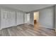 Bright bedroom features wood-look flooring, double closets, and neutral gray walls at 811 Pebblewood Dr, Brandon, FL 33511