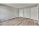 Bright bedroom featuring wood-look flooring and a double closet for ample storage at 811 Pebblewood Dr, Brandon, FL 33511