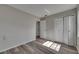 The spacious bedroom offers wood-look floors, grey paint, closet, and natural light at 811 Pebblewood Dr, Brandon, FL 33511