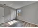 A bright bedroom showcases wood-look floors, fresh light-grey paint, and a closet at 811 Pebblewood Dr, Brandon, FL 33511