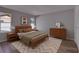 Comfortable bedroom featuring hardwood floors, neutral walls, and two large windows for plenty of natural light at 811 Pebblewood Dr, Brandon, FL 33511