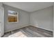 A bright bedroom features wood-look floors, a window, and light grey paint at 811 Pebblewood Dr, Brandon, FL 33511
