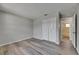 A bright bedroom showcases wood-look floors, fresh light-grey paint, and ensuite at 811 Pebblewood Dr, Brandon, FL 33511