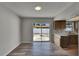 Bright dining room with modern wood floors, sliding glass doors to backyard, with views to kitchen at 811 Pebblewood Dr, Brandon, FL 33511