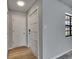 Home entryway featuring tile and wooden flooring, a front door, and hallway door at 811 Pebblewood Dr, Brandon, FL 33511