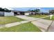 Spacious home with a long driveway, manicured lawn, and fenced yard in a friendly neighborhood at 811 Pebblewood Dr, Brandon, FL 33511
