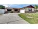 Charming single-story home with a brick and siding exterior, attached garage, and curved driveway at 811 Pebblewood Dr, Brandon, FL 33511