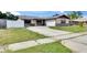 Well-maintained home with a long driveway, manicured lawn, and charming curb appeal at 811 Pebblewood Dr, Brandon, FL 33511
