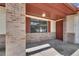 Covered front porch with brick columns, painted ceiling, and a traditional exterior door at 811 Pebblewood Dr, Brandon, FL 33511