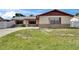 Home featuring a quaint, single-story facade and well-maintained lawn in a suburban neighborhood at 811 Pebblewood Dr, Brandon, FL 33511