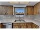 Close-up of kitchen with stainless steel sink and dishwasher with wooden cabinets at 811 Pebblewood Dr, Brandon, FL 33511