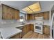 Functional kitchen featuring white countertops, wood cabinets, and modern appliances at 811 Pebblewood Dr, Brandon, FL 33511