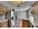 Modern kitchen with stainless steel refrigerator, gray walls, and flowing into living area at 811 Pebblewood Dr, Brandon, FL 33511