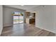 Living room with wood flooring, sliding glass doors, and view of the kitchen at 811 Pebblewood Dr, Brandon, FL 33511
