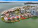 Waterfront condominiums with red tile roofs are nestled along the tranquil bay, offering scenic views and convenient parking at 868 Bayway Blvd # 206, Clearwater Beach, FL 33767