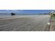 Expansive sandy beach ready for visitors with water and bridge views in the background at 868 Bayway Blvd # 206, Clearwater Beach, FL 33767