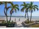 Private beach access with white sand and tropical palms, ideal for enjoying the coastal lifestyle at 868 Bayway Blvd # 206, Clearwater Beach, FL 33767