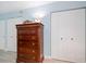 Charming dresser with decor set between two double-door closets and bright overhead lighting at 868 Bayway Blvd # 206, Clearwater Beach, FL 33767