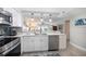 Well-lit kitchen with stainless appliances, white cabinets, and an open view to the living space at 868 Bayway Blvd # 206, Clearwater Beach, FL 33767