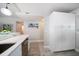 Bright, modern kitchen with stainless appliances, white cabinets, and quartz countertops at 868 Bayway Blvd # 206, Clearwater Beach, FL 33767