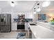 Bright kitchen features stainless appliances, white cabinetry, and quartz countertops, enhancing both style and functionality at 868 Bayway Blvd # 206, Clearwater Beach, FL 33767