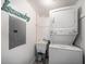Compact laundry room featuring a stacked washer and dryer and utility sink at 868 Bayway Blvd # 206, Clearwater Beach, FL 33767