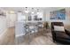 Inviting living area features a breakfast bar, view of the kitchen, and a comfortable chair with tasteful accents at 868 Bayway Blvd # 206, Clearwater Beach, FL 33767