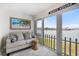 Cozy living room with beach decor, comfortable seating, and sliders to patio overlooking the water at 868 Bayway Blvd # 206, Clearwater Beach, FL 33767