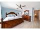 Spacious bedroom with a decorative ceiling fan and beautiful wood furnishings at 868 Bayway Blvd # 206, Clearwater Beach, FL 33767