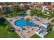 Aerial view of the community pool, including the hot tub and outdoor seating and lounge chairs at 868 Bayway Blvd # 206, Clearwater Beach, FL 33767