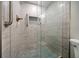 Shower with decorative tile and a glass door featuring custom tiling at 868 Bayway Blvd # 206, Clearwater Beach, FL 33767