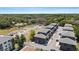 Scenic aerial view of a neighborhood featuring modern townhouses, lush greenery, and a clear view of the city skyline in the distance at 8723 Palm Ranches Pl, Tampa, FL 33614