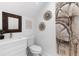 Modern bathroom with a sleek white vanity, toilet, and decorative wall art at 8723 Palm Ranches Pl, Tampa, FL 33614