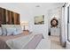 Tranquil bedroom featuring soft textures, art pieces, and a bathroom en suite at 8723 Palm Ranches Pl, Tampa, FL 33614