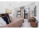 Comfortable bedroom with a large window, soft bedding, and stylish decor and furniture at 8723 Palm Ranches Pl, Tampa, FL 33614