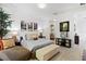 Bright bedroom featuring hardwood floors, a sitting area, and stylish decor at 8723 Palm Ranches Pl, Tampa, FL 33614